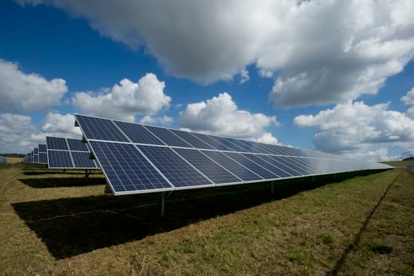 Solar panels on roof with blue sky - represents solar calculator/ROI concept